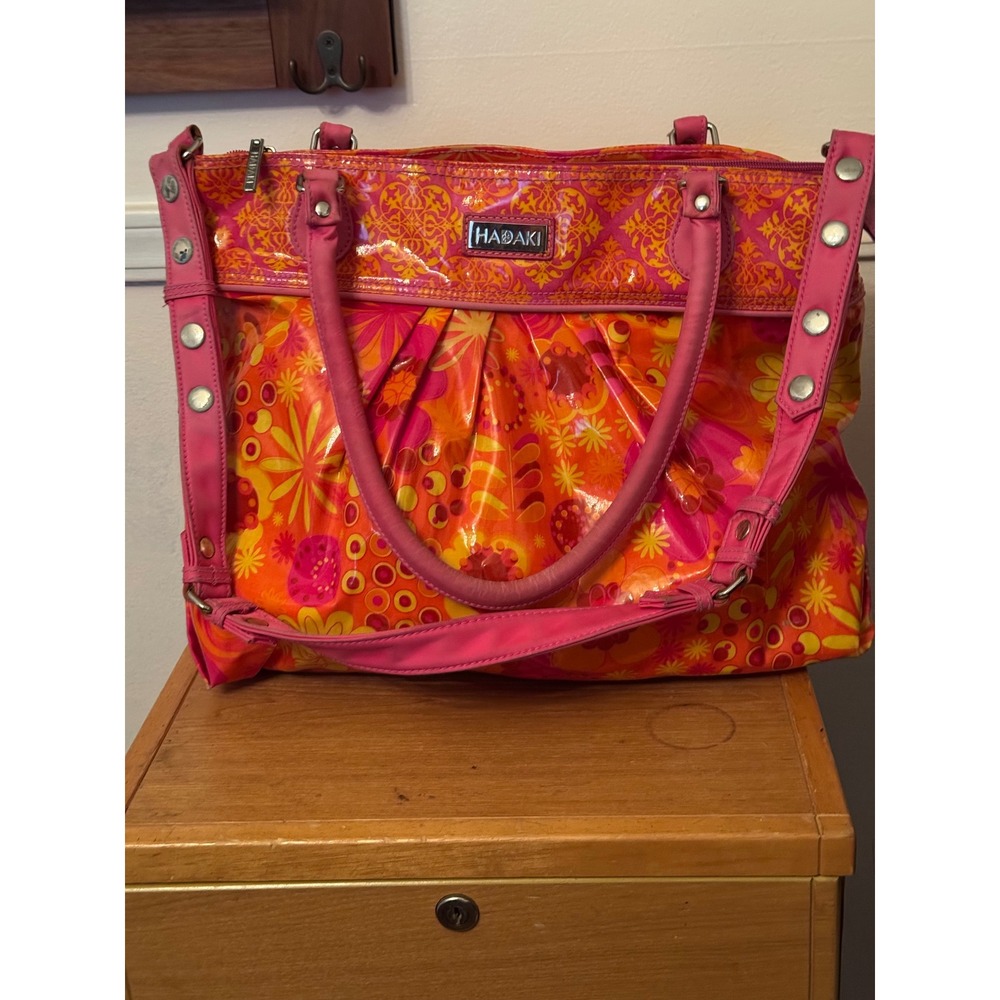 Hadaki floral shoulder bag, known for its bold, colorful‎ patterns